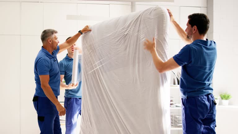 Professional Mover Delivering Mattresses and Furniture with Reliable Teamwork in New White Uniforms for Moving Company